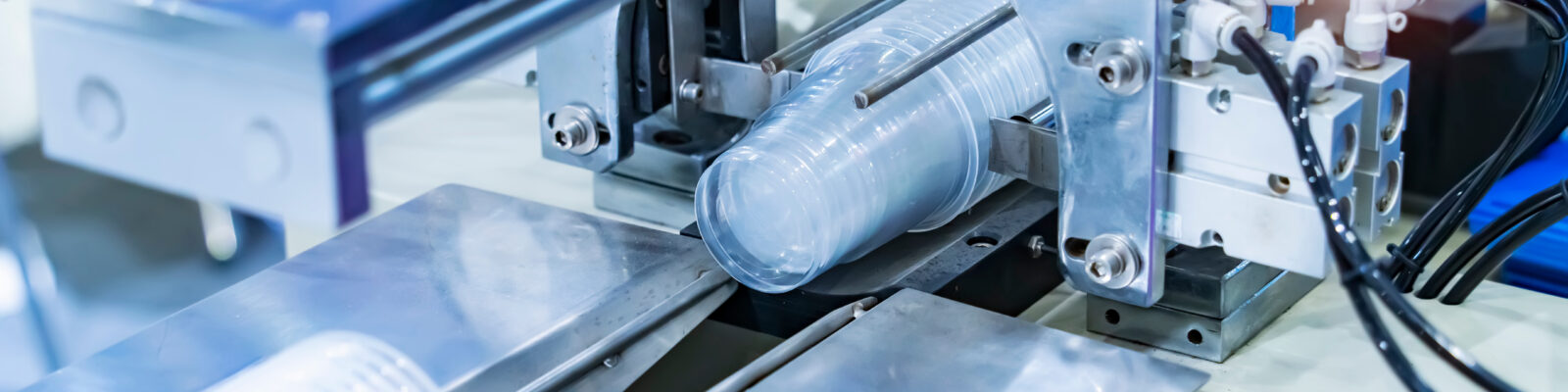 Stack of polypropylene food containers cup on conveyor belt of a